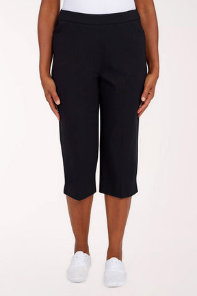 Black  capri pants worn by a person on a white background