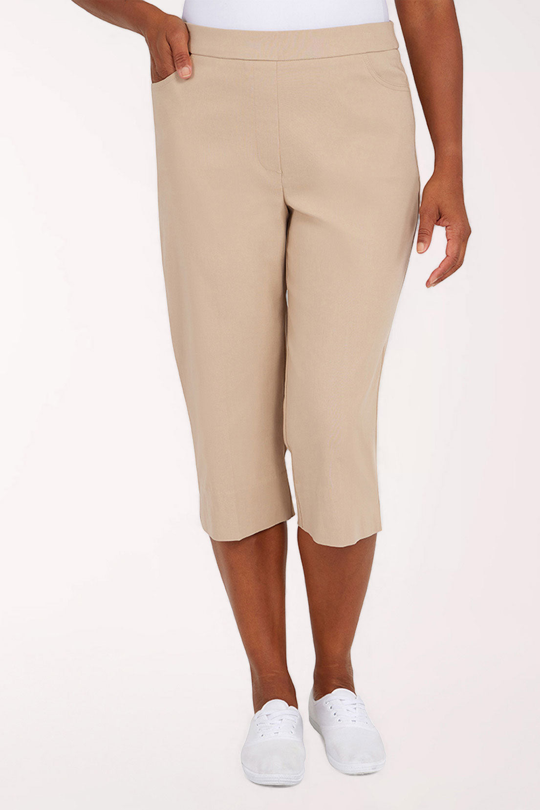 Beige capri pants worn by a person on a white background