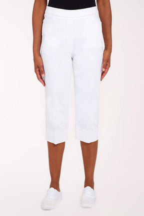 White capri pants worn by a person on a white background