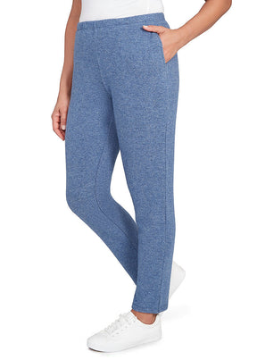 Person wearing blue pants with a white background