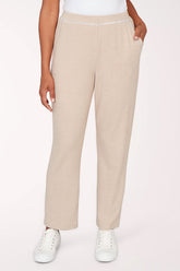 Beige pants worn by a person on a white background