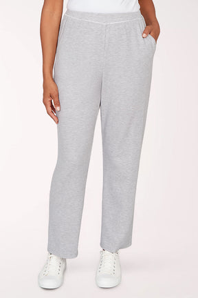 Gray sweatpants worn by a person on a light pink background