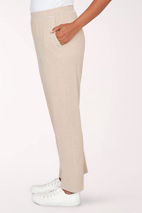 Beige pants worn by a person on a white background