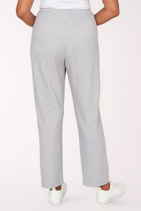 Gray sweatpants worn by a person on a light pink background