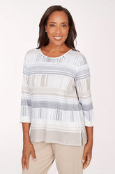 Woman wearing a striped top with a plain background