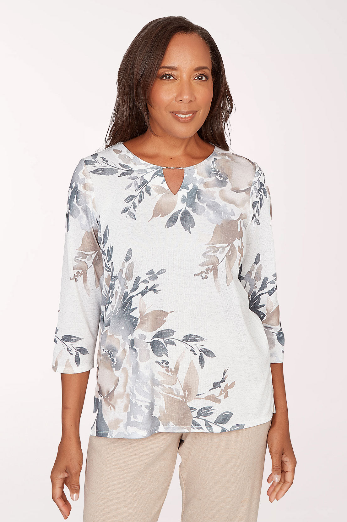 Woman wearing a floral blouse with a plain background
