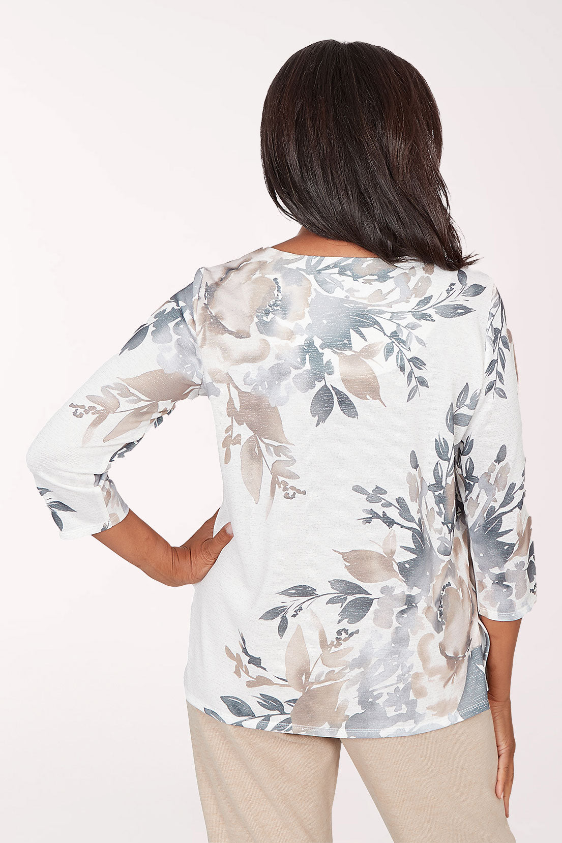 Woman wearing a floral blouse with a plain background