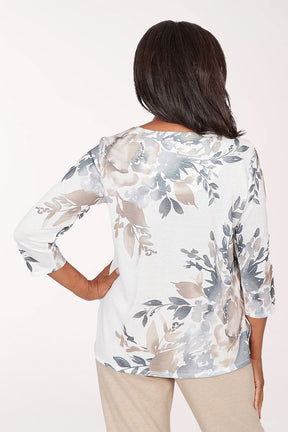 Woman wearing a floral blouse with a plain background