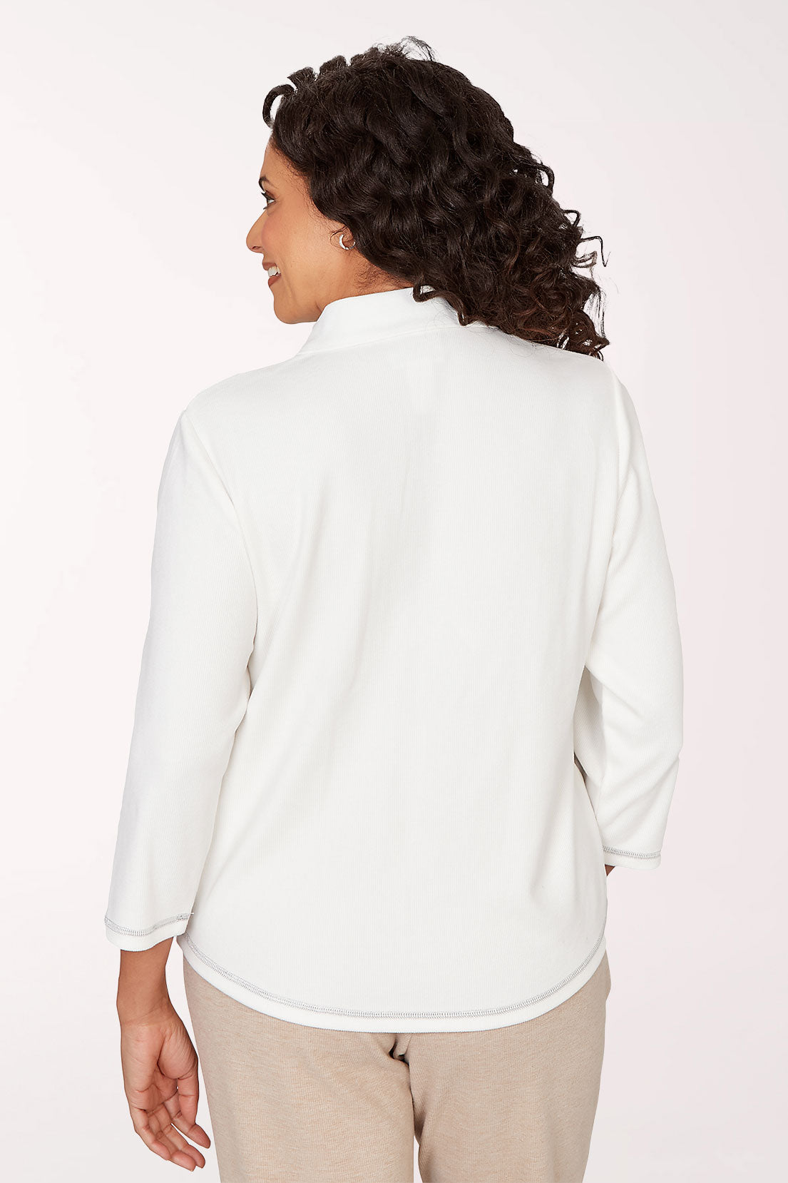 Woman wearing a color-blocked shirt with a plain background