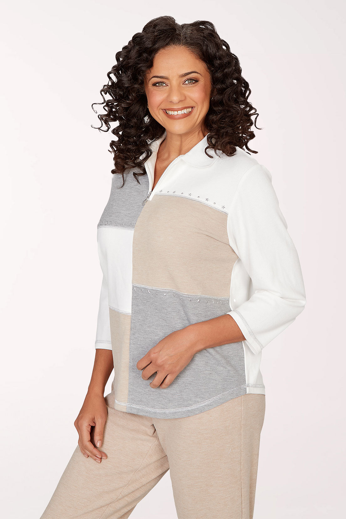 Woman wearing a color-blocked shirt with a plain background