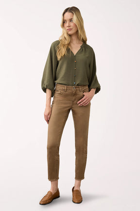 Woman wearing brown ankle pants