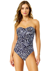 Woman wearing a strapless swimsuit with zebra pattern on a white background