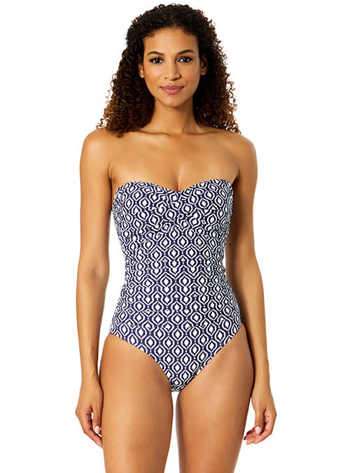 Woman wearing a strapless swimsuit with a geometric pattern on a white background