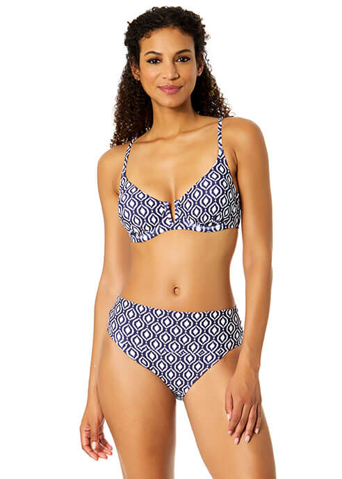 Woman wearing a blue and white patterned bikini on a white background