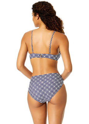 Woman wearing a blue and white patterned bikini on a white background