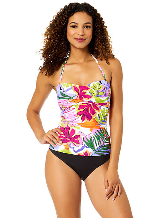 Woman wearing a colorful floral swimsuit on a white background