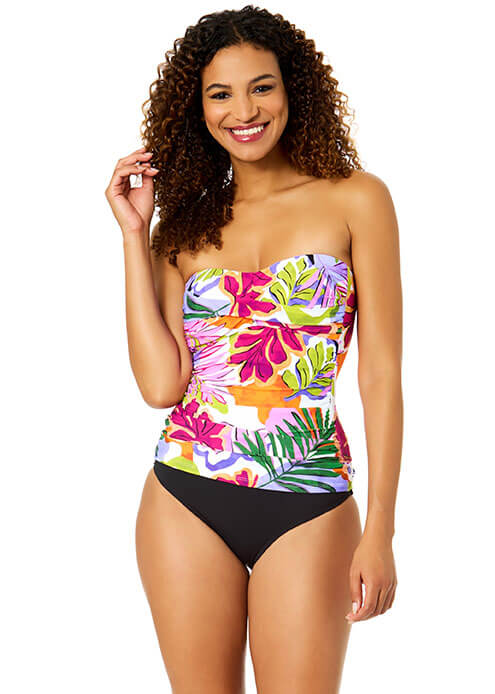 Woman wearing a colorful strapless swimsuit with floral design on a white background