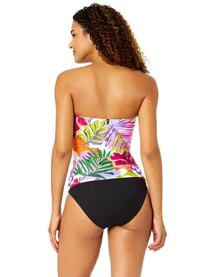 Woman wearing a colorful strapless swimsuit with floral design on a white background