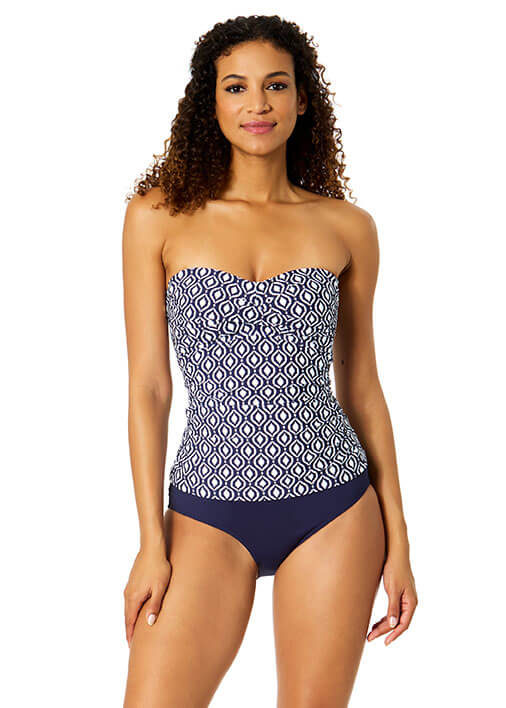 Woman wearing a strapless swimsuit with a geometric pattern on a white background