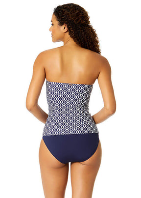Woman wearing a strapless swimsuit with geometric pattern on a white background