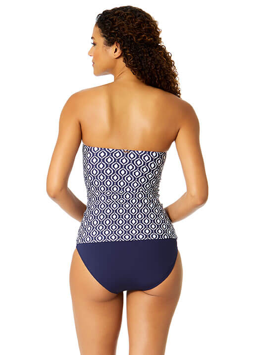 Woman wearing a strapless swimsuit with geometric pattern on a white background