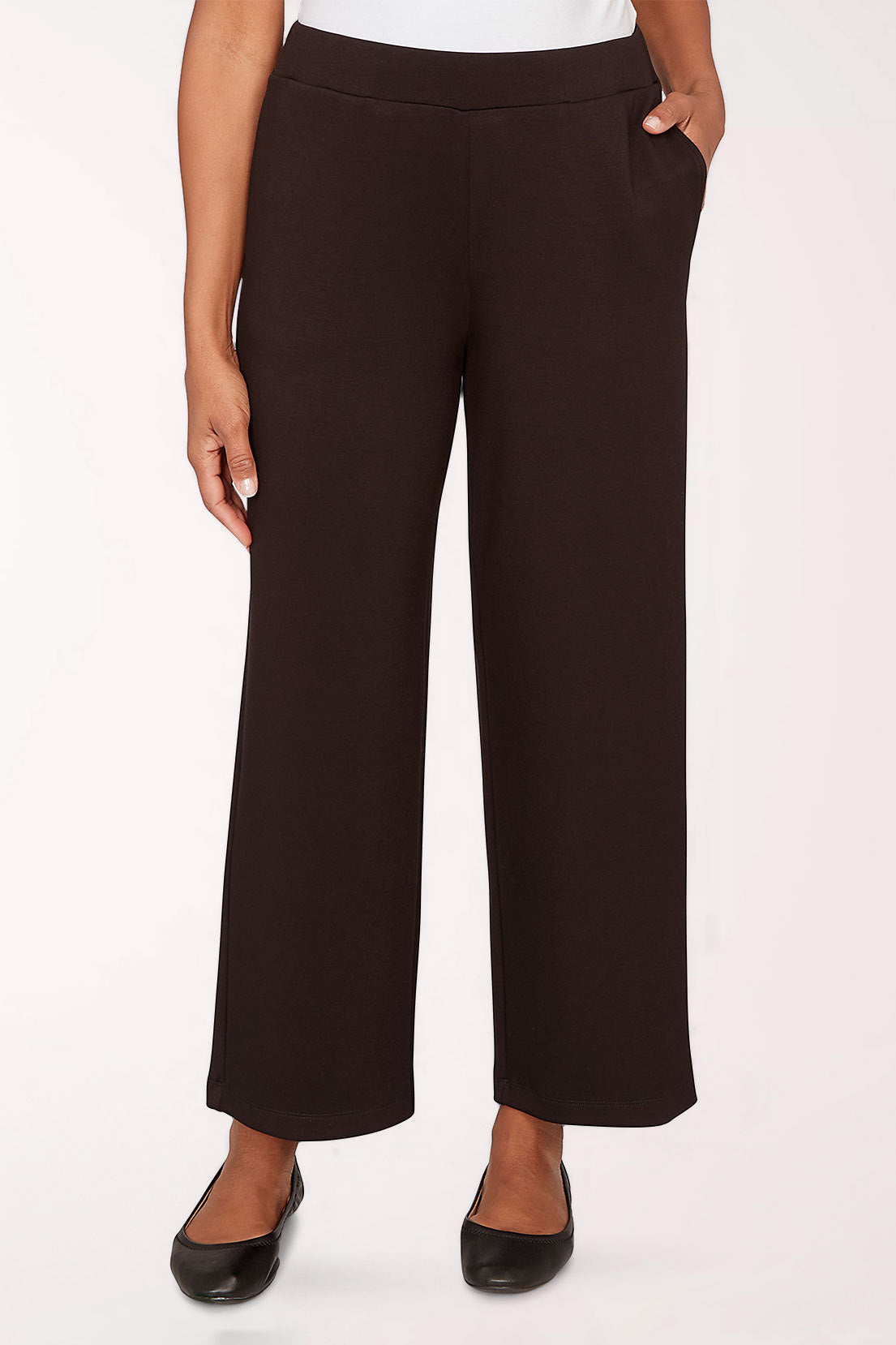 Black pants worn by a person on a white background