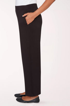 Black pants worn by a person on a white background