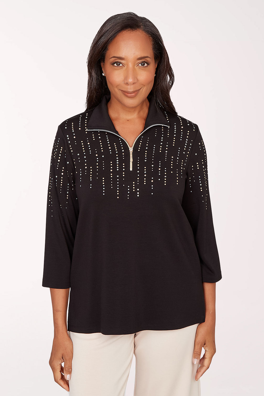 Woman wearing a black top with decorative trim on a white background