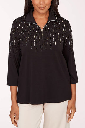 Woman wearing a black top with decorative trim on a white background