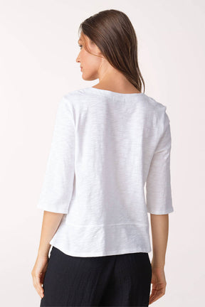 Woman wearing a white blouse with a plain background