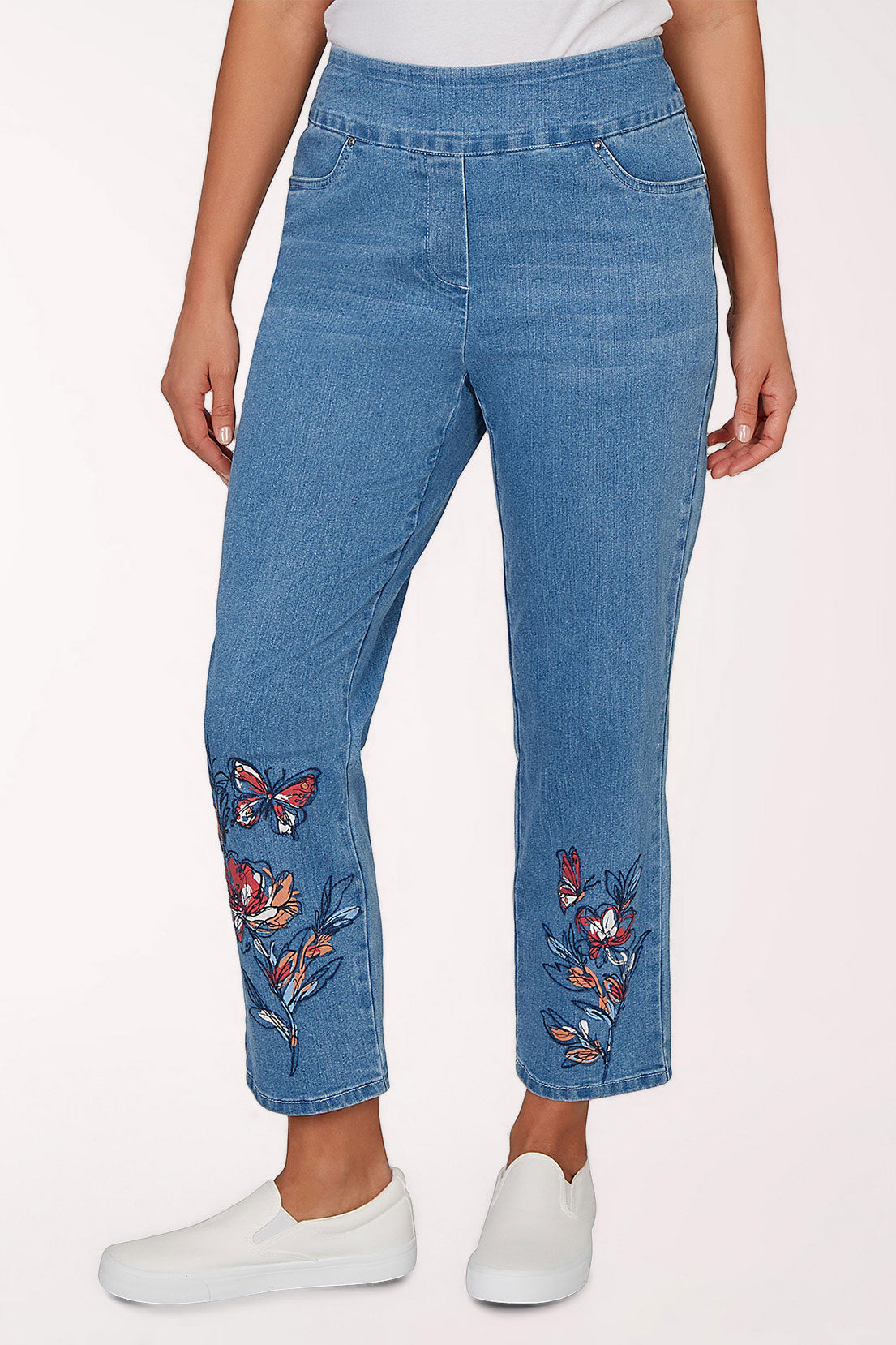 Blue jeans with butterfly embroidery on a white background