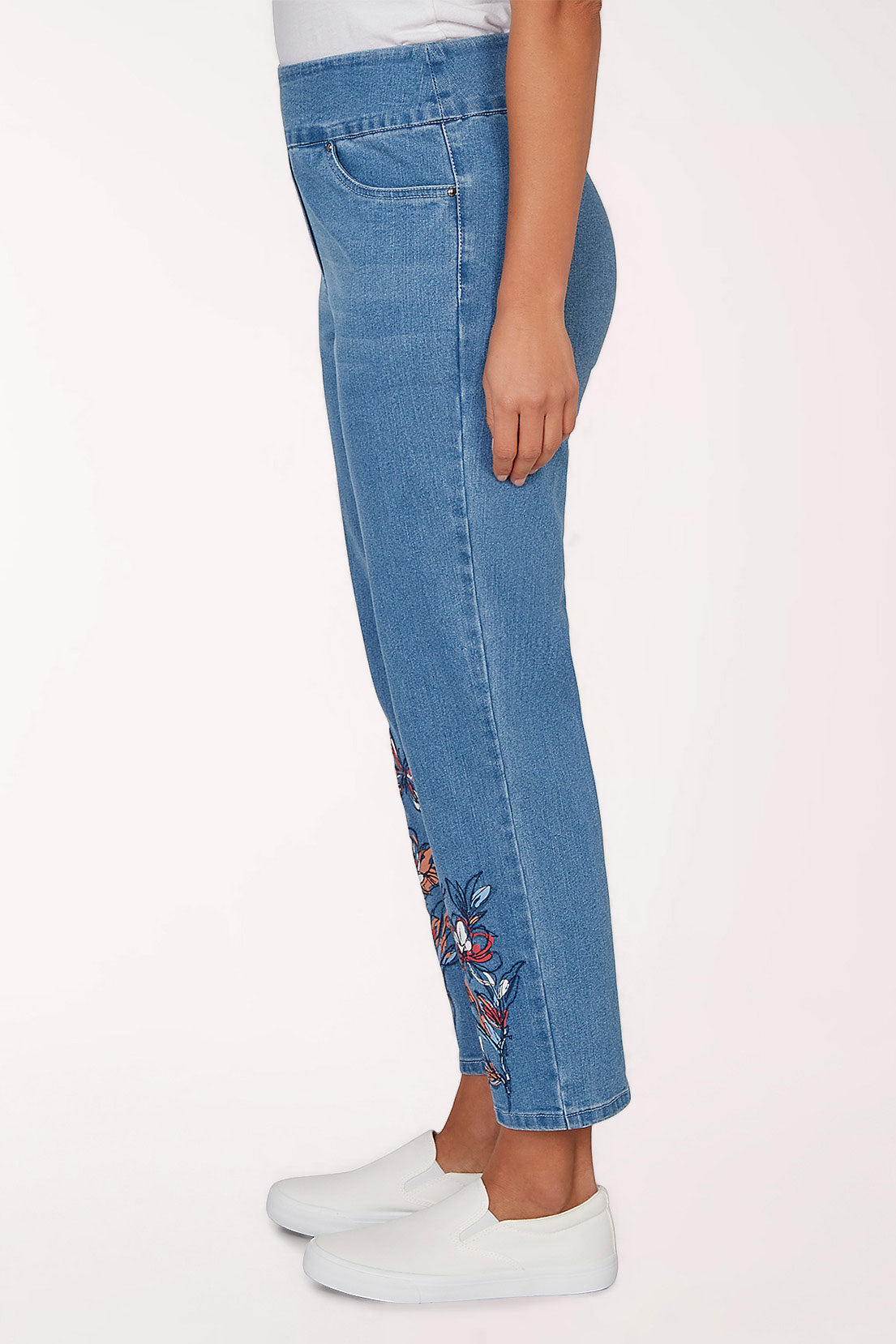 Blue jeans with butterfly embroidery on a white background