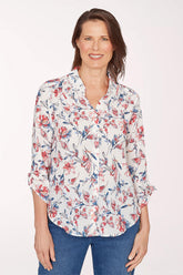 Woman wearing a floral blouse with a white background