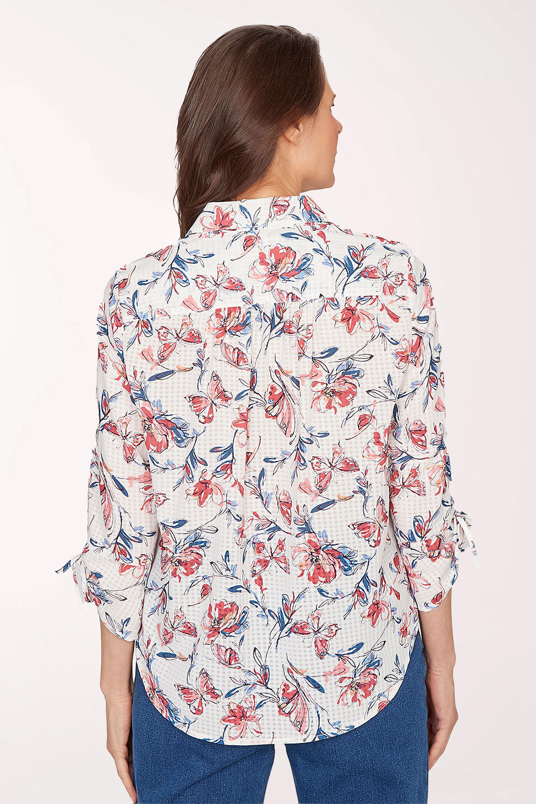 Woman wearing a floral blouse with a white background