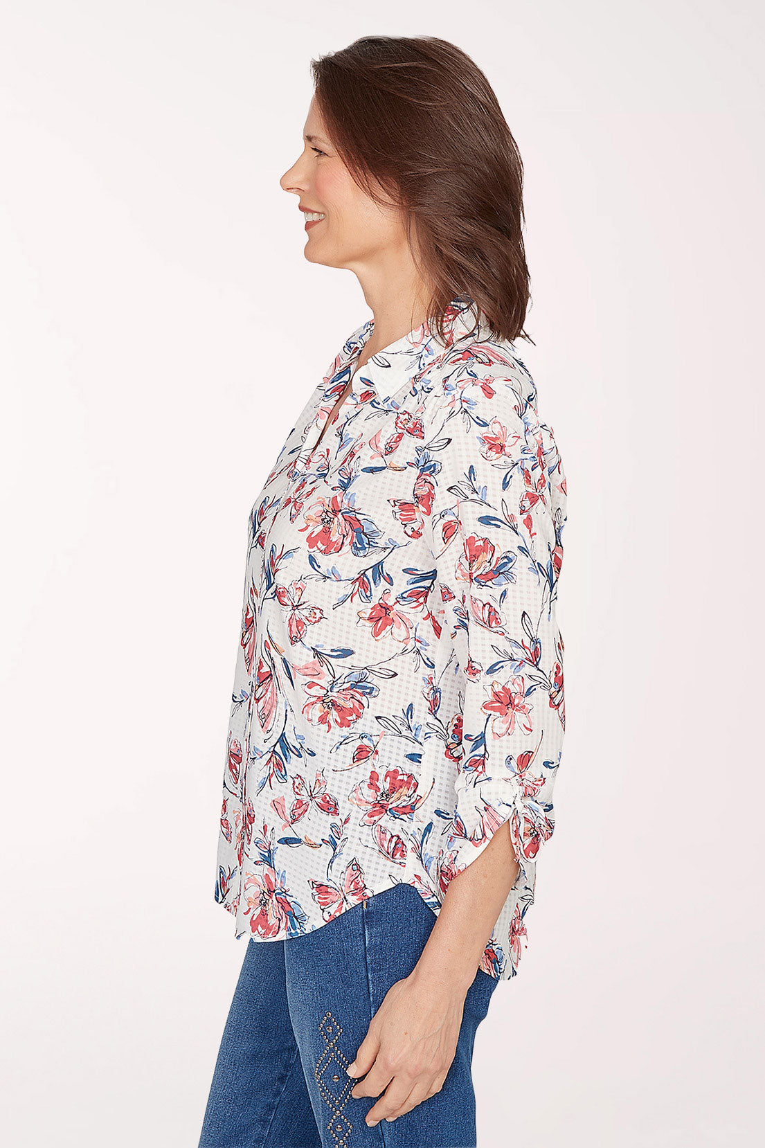 Woman wearing a floral blouse with a white background