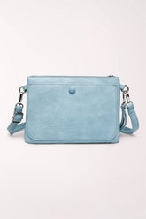 Front view of the 22 Tote Two-Sided Crossbody Bag in baby blue faux leather: a rectangular bag with a front flap pocket closed by a snap button, silver hardware and an adjustable crossbody strap.