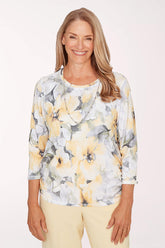 Woman wearing a floral blouse with a plain background