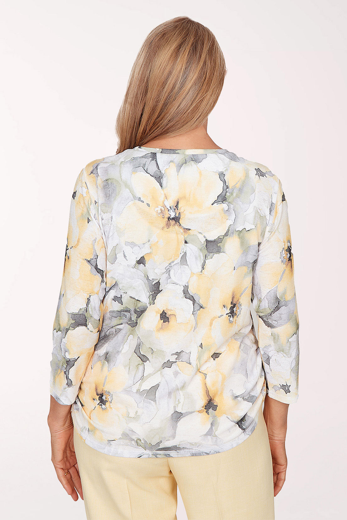 Woman wearing a floral blouse with a plain background