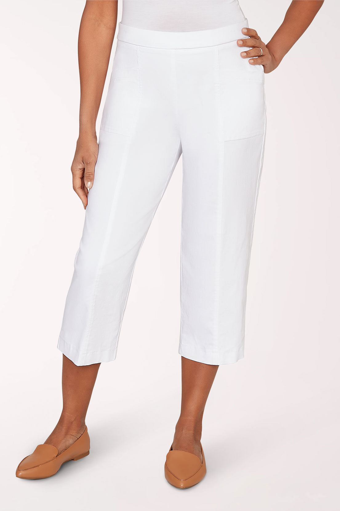 Person wearing white pants on a plain background