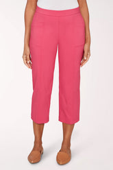 Person wearing bright pink capri pants on a white background
