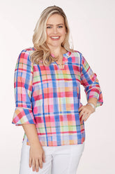 Woman wearing a colorful plaid shirt on a white background