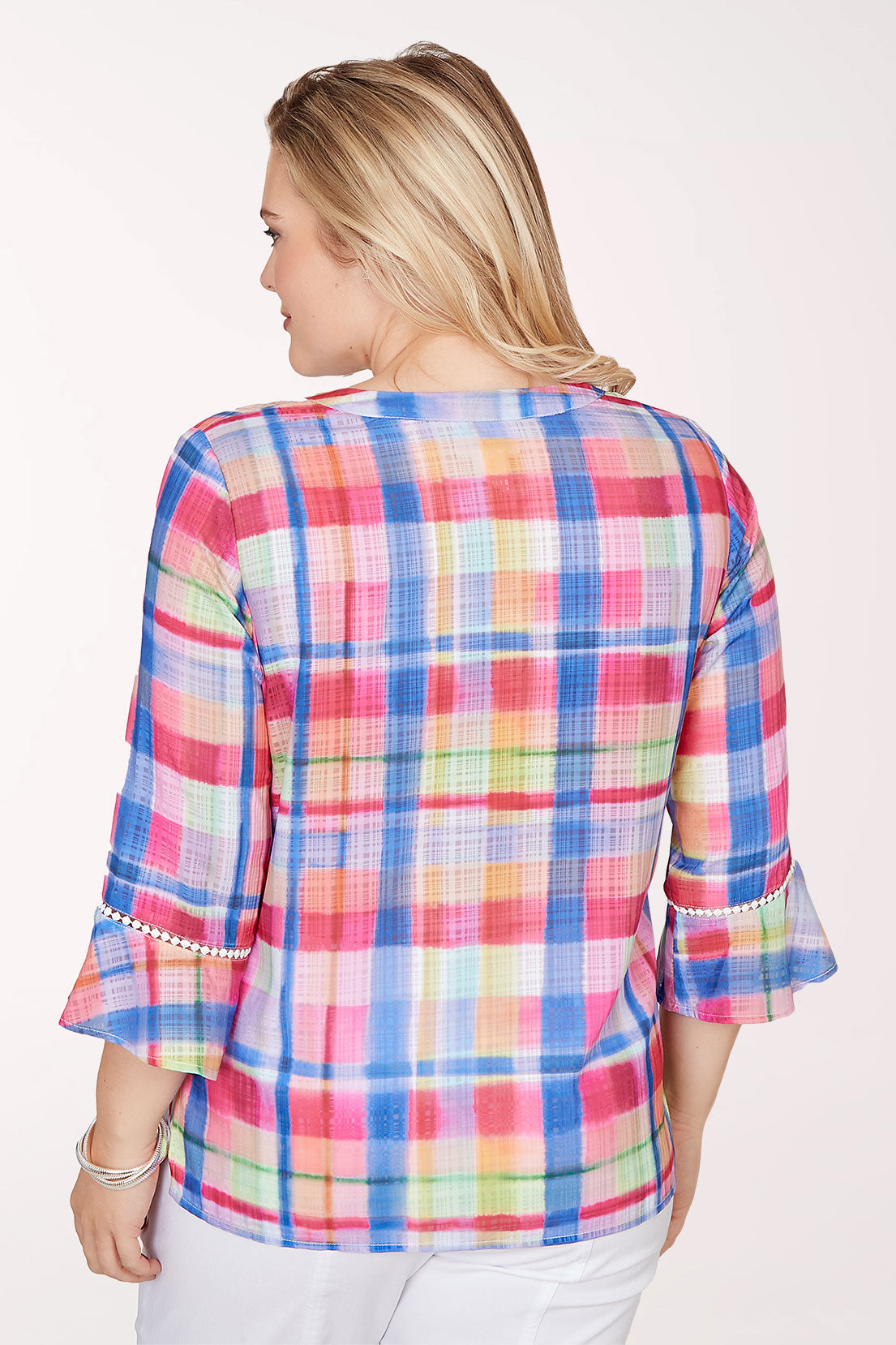 Woman wearing a colorful plaid shirt on a white background