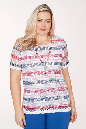 Woman wearing a patterned top with buttons on a white background