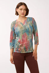 Woman wearing a 3/4 sleeve multicolored top 