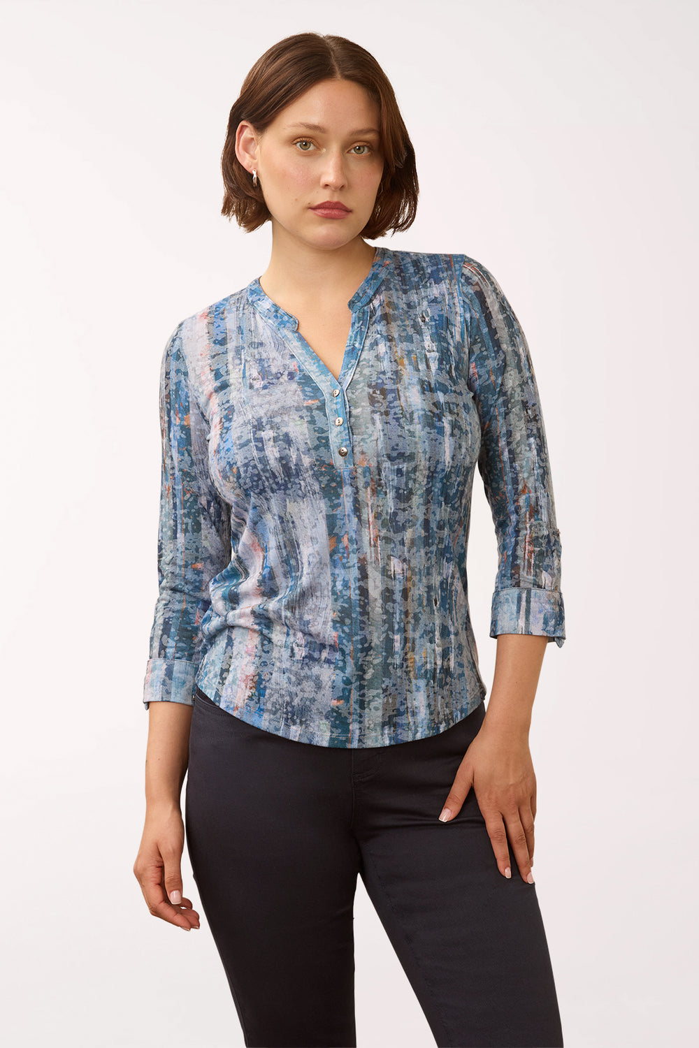 Woman wearing a 3/4 sleeve blue triple button henley top 