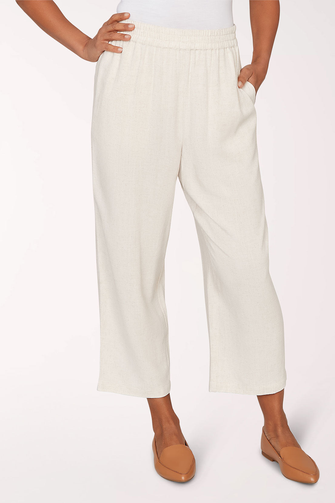 Person wearing white pants on a plain background