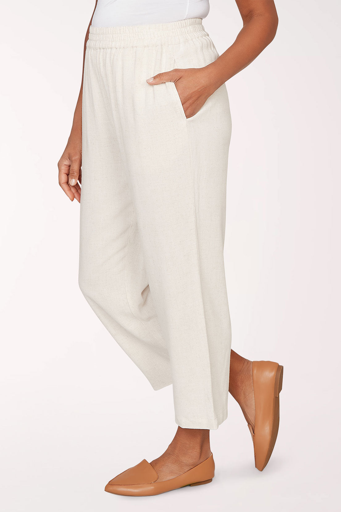 Person wearing white pants on a plain background