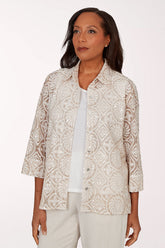 Woman wearing a patterned beige jacket over a white shirt on a white background