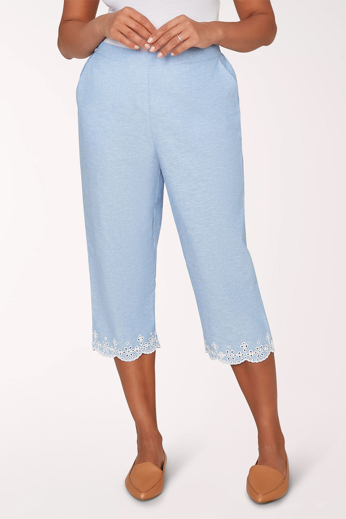 Light blue pants with lace trim worn by a person on a white background