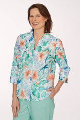 Woman wearing a colorful floral blouse with a white background